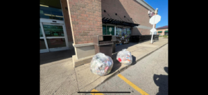 Two large clear bags of commercial junk and waste ready for pickup by Clean Sweep in Wilmington, NC.