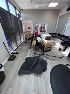A commercial space, possibly a salon, with boxes, chairs, and equipment piled up for junk removal by MLG Strong Hauling & Junk Removal LLC in Henderson, NV.