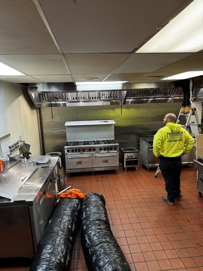 Workers from ProKitchen Solutions installing commercial kitchen equipment and exhaust hoods in Russiaville, IN