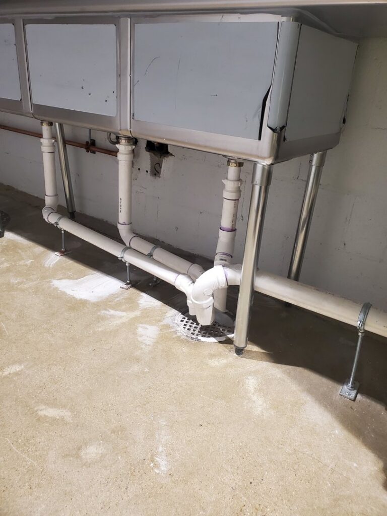 Commercial kitchen sinks with new plumbing installed underneath by Snyder Solutions LLC in Richmond, VA