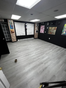 Commercial space with new LVP flooring and dark interior painting completed by Kings Handyman Services in Dallas, TX