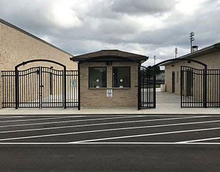 Commercial black metal entrance gates and fencing installed by R & C Fence in Fort Wayne, IN.
