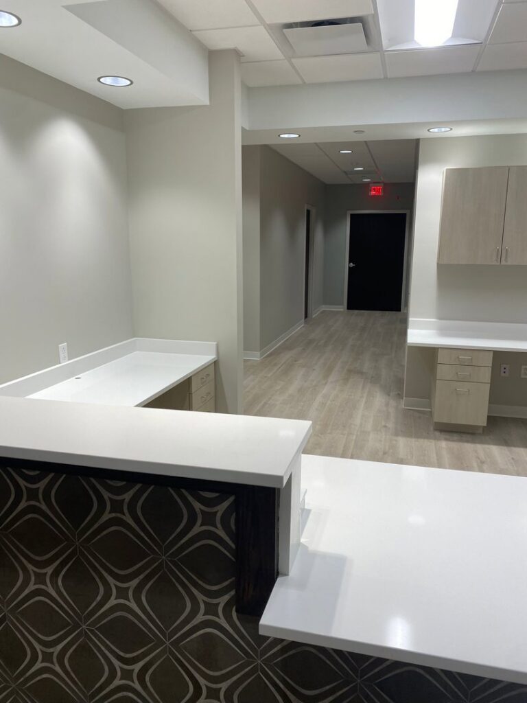 A completed commercial office build-out with reception area and modern finishes by Belair Inc. in Saint Cloud, FL