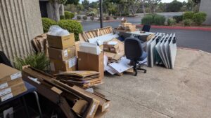A large pile of commercial office junk ready for removal by Impact Environmental Co. in El Cajon, CA.