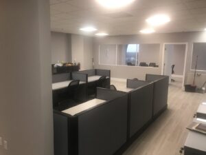 A commercial office renovation featuring new cubicles, flooring, and paint by BRM Construction in Miami, FL.