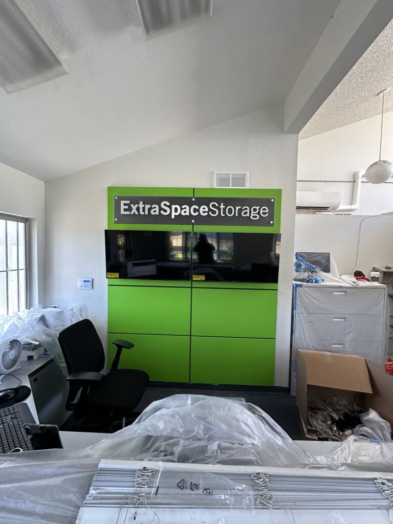 Commercial office setup with green panels and 'ExtraSpaceStorage' sign by Kennyman The Handyman Inc. in San Francisco, CA
