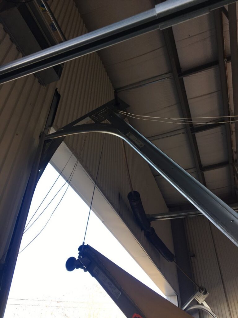 Close-up of a commercial overhead door track system, showing components serviced by Overhead Door Company of Columbus in Columbus, GA.