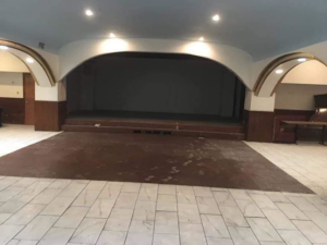 A commercial space undergoing a painting job with a paint sprayer by Landon and David handyman in Wichita, KS.