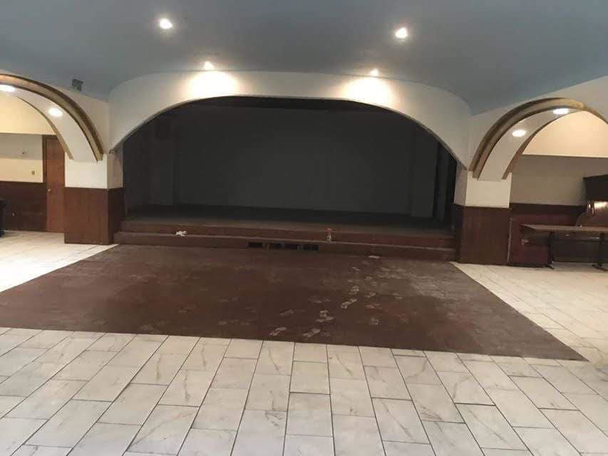 A commercial space undergoing a painting job with a paint sprayer by Landon and David handyman in Wichita, KS.