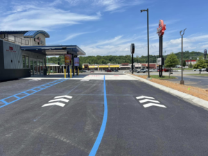 Detailed blue line and arrow striping in a commercial parking lot completed by Marine One Striping in Clarksville, TN.