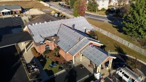 Workers from First Choice Roofing installing a new roof on a commercial building in Cary, NC.