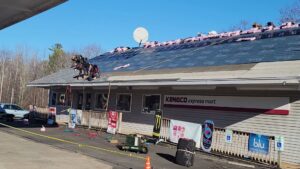 Workers installing a new roof on a commercial building for Joe's Roofing in Strongsville, OH.