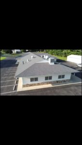 An aerial view of a commercial building with a newly installed roof by Artstone Exteriors & Renovations in Myersville, MD.