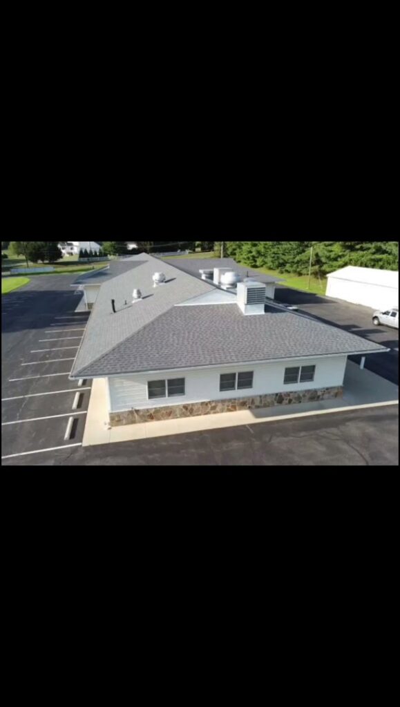 An aerial view of a commercial building with a newly installed roof by Artstone Exteriors & Renovations in Myersville, MD.