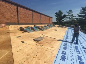 A commercial roofing project in progress with new underlayment being installed by Gwen Co in St. Louis, MO.