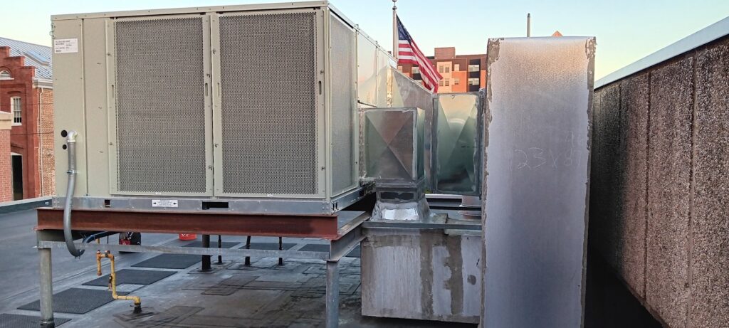 A large commercial rooftop HVAC unit installed on a building, serviced by Pollock HVAC & Electrical in Albany, GA