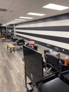 A commercial salon interior with freshly painted black and white striped walls by In Goode Hands LLC in Beckley, WV.