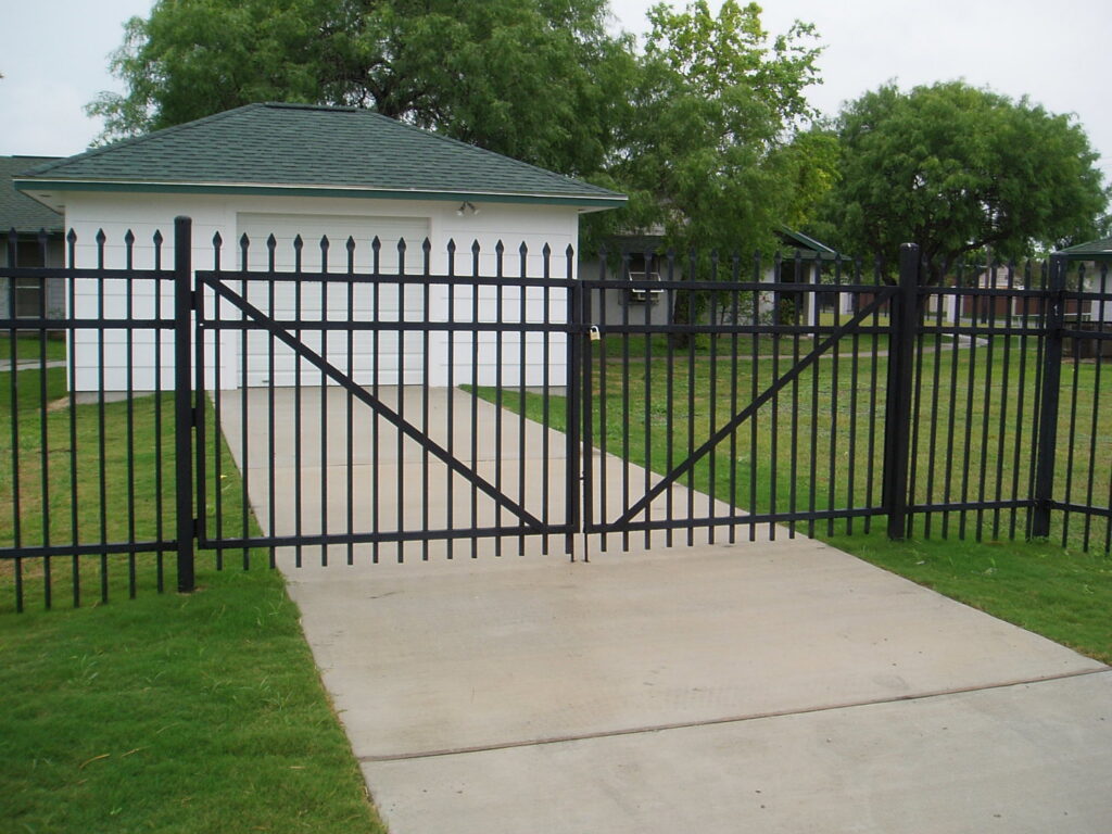 A newly installed black metal security fence and gate by Gourley Contractors, LLC in Corpus Christi, TX.
