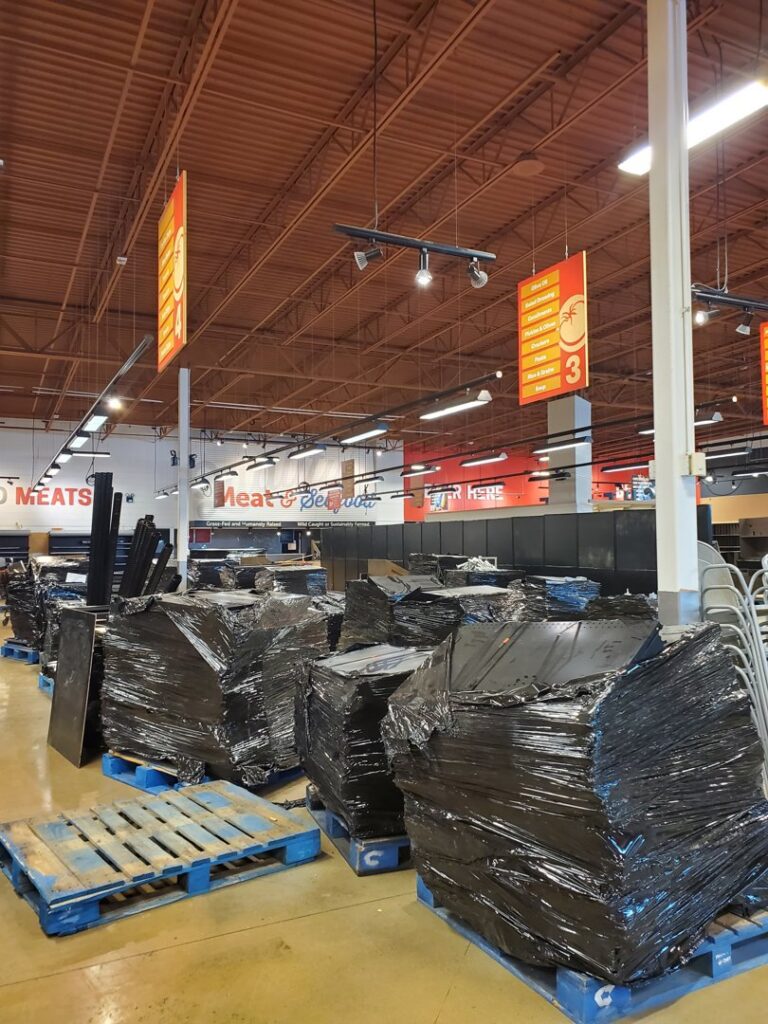 Commercial shelving and fixtures wrapped for removal on pallets by Jugganott Recycling, LLC in Orlando, FL.