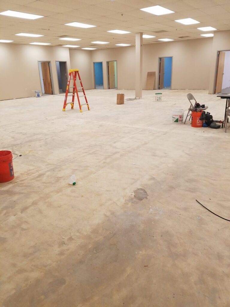 An empty commercial space with concrete floor ready for renovation by JMQ Contractor INC in Philadelphia, PA