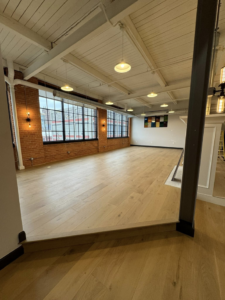 A newly renovated commercial or loft space with hardwood floors and exposed brick by Hazelton Services Inc in Warren, MI.
