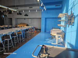 A commercial space undergoing renovation with blue and grey walls by Logical Drywall and Painting in St. Louis, MO.