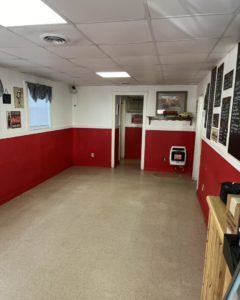 A commercial space renovation showing red and white walls and a plain tiled floor by A 2 Z Home Services - Fairmont WV.