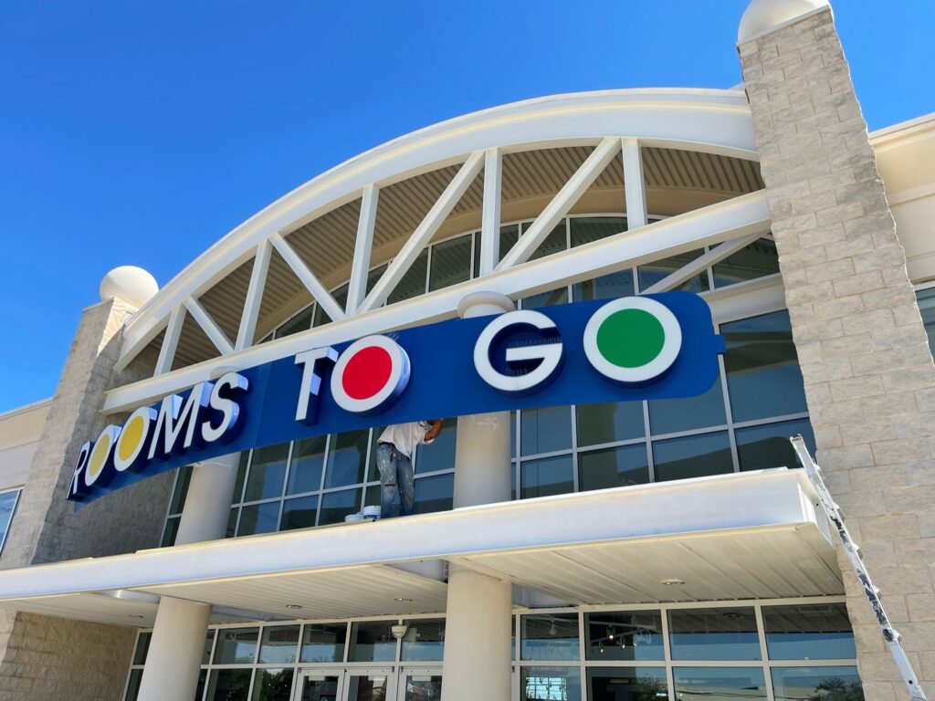 Commercial storefront painting at Rooms To Go by Painting Professionals, Inc. in Houston, TX