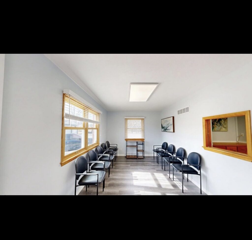 A newly remodeled commercial waiting room with light blue walls and new flooring by EJ Drywall Plus in Kearney, NE.