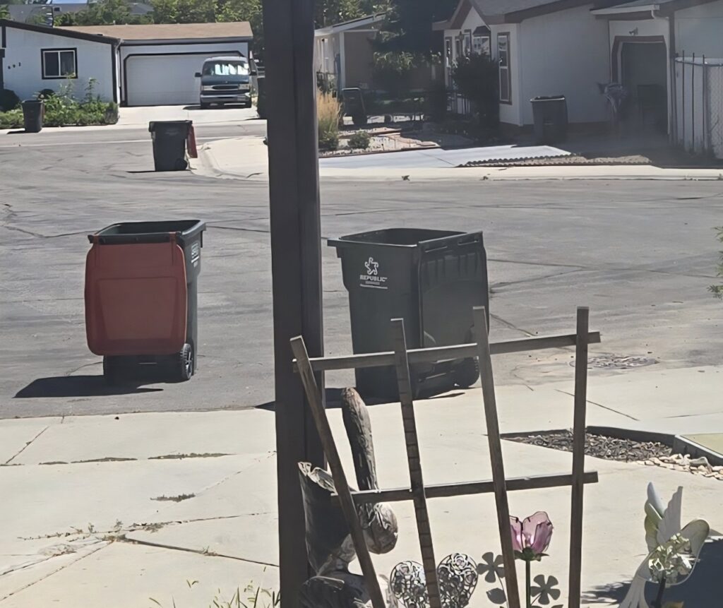 A commercial waste collection area with a partially visible dumpster and trash, illustrating junk removal needs in Meridian, ID.