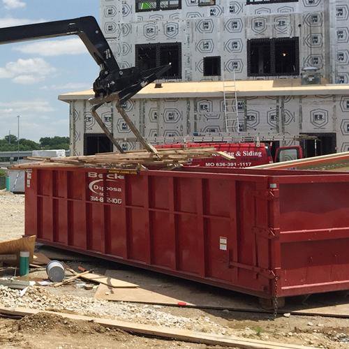 A commercial waste dumpster with a chute from Beck Disposal Inc. in St. Louis, MO