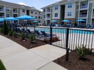 A newly installed black metal fence around a community swimming pool area by Minors Fences in Ashland, VA.