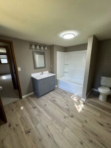 A complete bathroom remodel featuring new vanity, tub, and flooring by Midwest Handyman LLC in West Fargo, ND.
