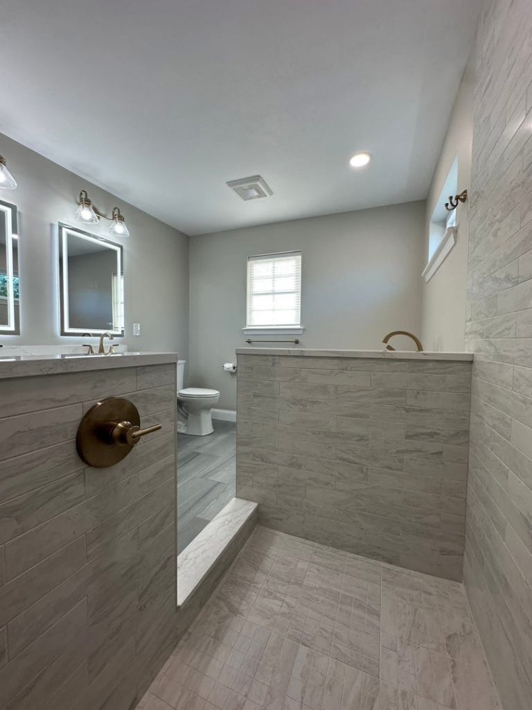 A complete bathroom remodel showcasing a walk-in shower and modern vanity by Quality Work Home Services in Syracuse, NY.