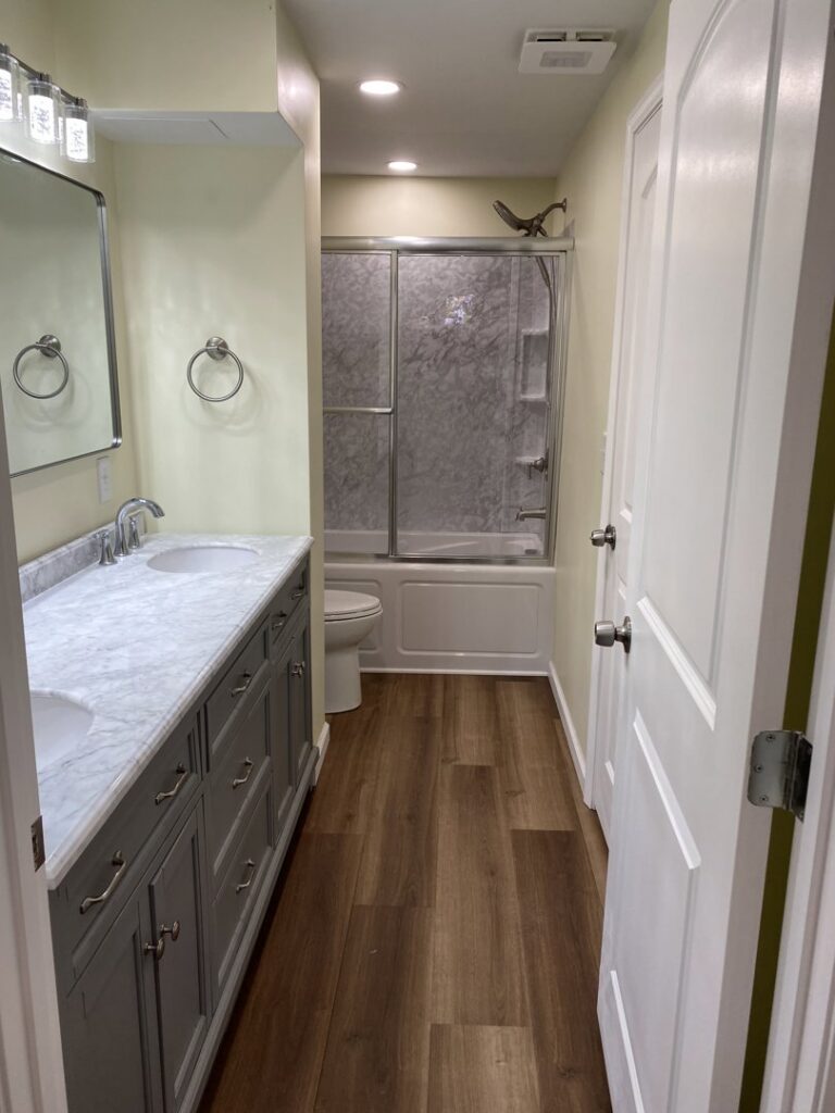 A complete bathroom remodel with a double vanity and new shower by Top Gunn Family Construction in Truxton, MO.
