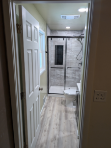 A complete bathroom renovation showcasing new shower, toilet, and vanity by A&A Property Renovations LLC in Green Bay, WI.