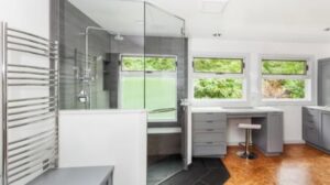 A complete modern bathroom renovation featuring a glass shower enclosure by Jar Hardware in Hialeah, FL.