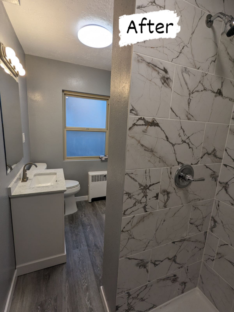 A complete bathroom renovation showcasing a new vanity, toilet, and tiled shower completed by Joel's Handyman in Ogden, UT.