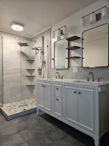 A complete bathroom renovation with modern design, including a walk-in shower and double vanity, by Huynh Design & Remodeling in Alexandria, VA.