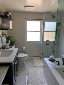 A complete bathroom renovation showcasing new vanity, toilet, and shower by Solis and Son Construction in Denver, CO.