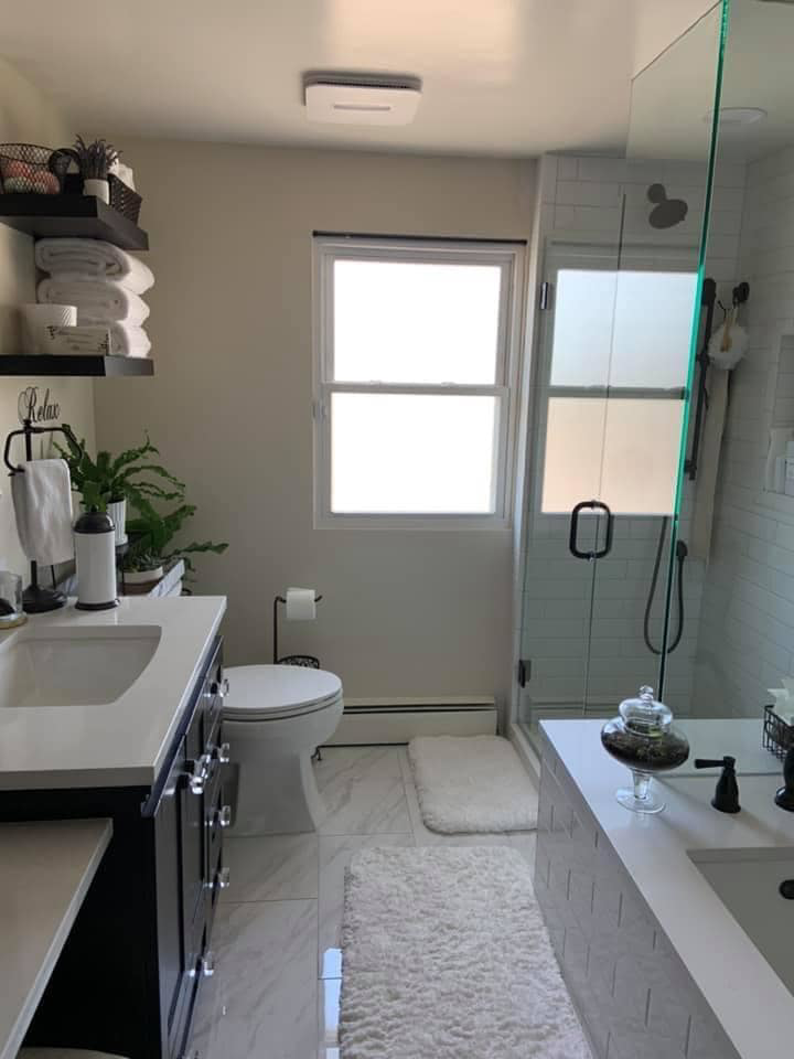 A complete bathroom renovation showcasing new vanity, toilet, and shower by Solis and Son Construction in Denver, CO.