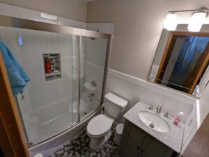 A complete bathroom renovation featuring a new vanity, toilet, and shower by Better Than Your Last Handyman in St. Charles, MO.