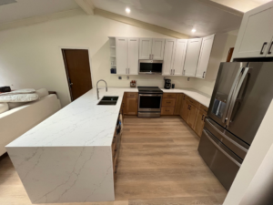 A complete kitchen remodel showcasing a large island, new cabinets, and stainless steel appliances by Precision Home Improvement in Virginia Beach, VA.