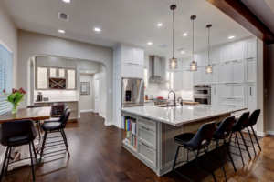 A complete kitchen renovation showcasing an open-concept design and wet bar by Adams Company in Cedar Park, TX