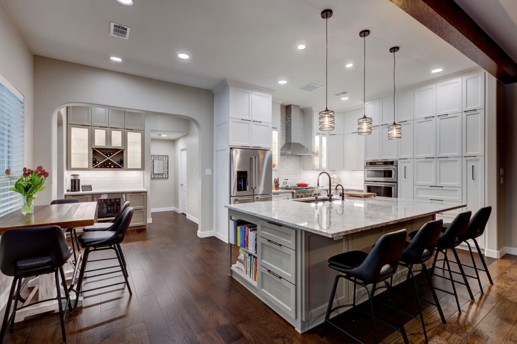 A complete kitchen renovation showcasing an open-concept design and wet bar by Adams Company in Cedar Park, TX