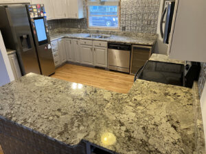 A complete kitchen renovation featuring new granite countertops and stainless steel appliances by Fine Design Marble And Granite in Springfield, MA.