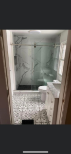 Complete modern bathroom remodel featuring a new shower, toilet, and vanity by Do It All Contracting in Rochester, NY.
