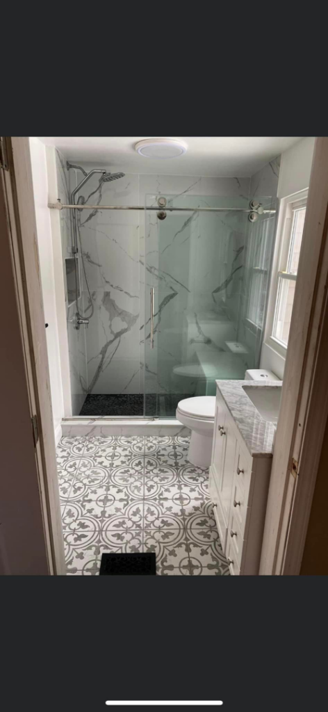 Complete modern bathroom remodel featuring a new shower, toilet, and vanity by Do It All Contracting in Rochester, NY.