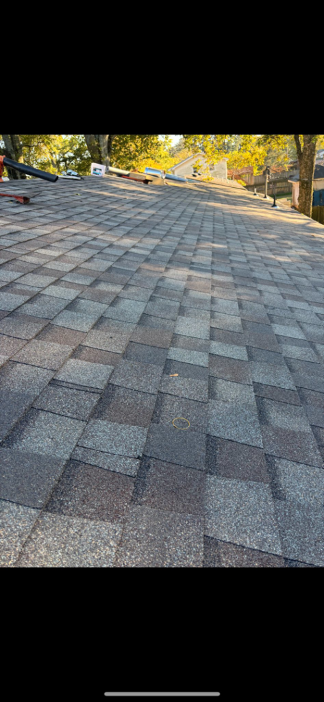 A view of a newly completed asphalt shingle roof, demonstrating quality roofing services from AK Overhead Door & Handyman Services in Wetumpka, AL.