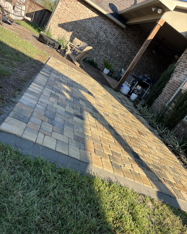 A beautifully completed backyard paver patio and walkway installed by Pedro Pavers LLC in New Orleans, LA